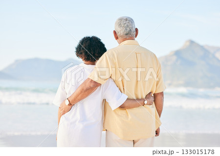 Senior couple at beach, hug and travel, retirement and love outdoor, vacation with ocean view and relax in nature. Peace, zen and tropical island, man and woman watching sea waves, back and wellness Senior couple at beach, hug and travel, retirement and love outdoor, vacation with ocean view and relax in nature. Peace, zen and tropical island, man and woman watching sea waves, back and wellness 133015178