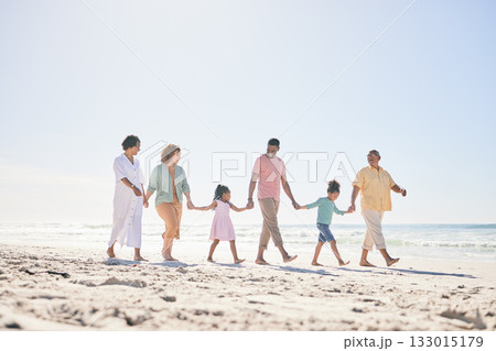 Happy family walking on beach holding hands with children for love, bonding and quality time together. Relax, smile and kids with mom, dad and grandparents on holiday, summer vacation and weekend Happy family walking on beach holding hands with children for love, bonding and quality time together. Relax, smile and kids with mom, dad and grandparents on holiday, summer vacation and weekend 133015179