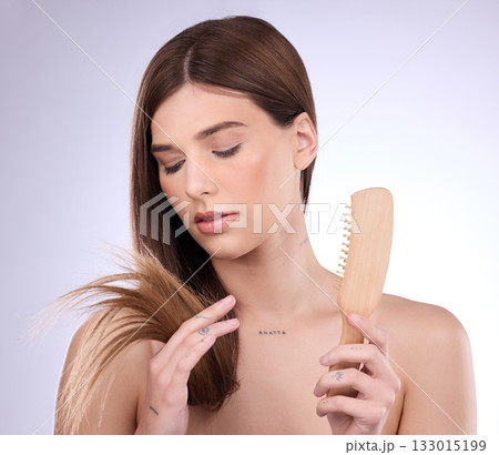 Split ends, hair and woman holding a brush in a isolated, white background and studio. Beauty salon, dye treatment damage and cosmetics of a young female model upset about haircut growth problem Split ends, hair and woman holding a brush in a isolated, white background and studio. Beauty salon, dye treatment damage and cosmetics of a young female model upset about haircut growth problem 133015199