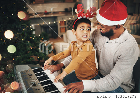 Happy family, father and kid at piano for christmas celebration, song and xmas at home. Parent, boy child and teaching keyboard instrument, festive music or celebrate holiday spirit together in house Happy family, father and kid at piano for christmas celebration, song and xmas at home. Parent, boy child and teaching keyboard instrument, festive music or celebrate holiday spirit together in house 133015278