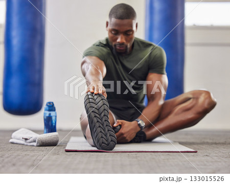 Black man, stretching legs and fitness in gym for training, performance and bodybuilding. Bodybuilder warm up for strong feet, sports workout and start healthy exercise for mobility, energy and power 133015526