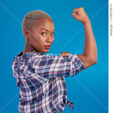 Portrait, black woman and flex arms on blue background, studio and backdrop of freedom, empowerment or pride. Female model, bicep and girl power in fight of gender equality, strong muscle or feminism 133015651