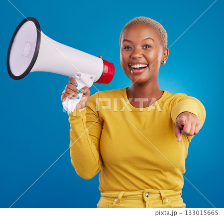 Black woman, megaphone and pointing, protest and voice, freedom of speech and activism on blue background. Happy female, broadcast and speak out, rally and portrait, loudspeaker and opinion in studio Black woman, megaphone and pointing, protest and voice, freedom of speech and activism on blue background. Happy female, broadcast and speak out, rally and portrait, loudspeaker and opinion in studio 133015665