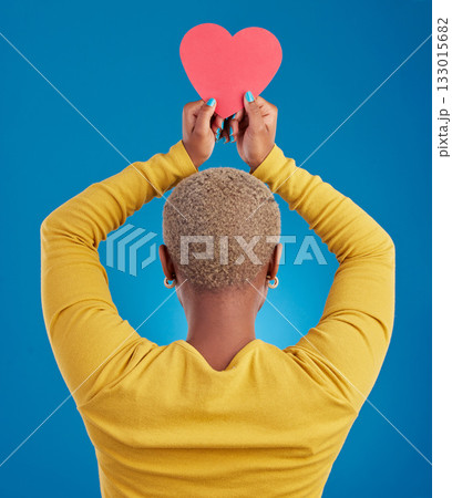 Paper, heart and back of black woman in studio for love, date and kindness. Invitation, romance and feelings with female and shape isolated on blue background for emotion, support and affectionate 133015682