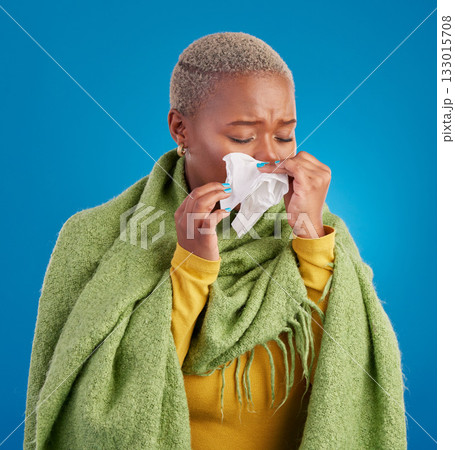 Sick black woman, tissue and blowing nose in studio, blue background or hayfever allergies, cold or winter virus. Female model, sneeze and influenza allergy of health problem, covid risk or sinusitis Sick black woman, tissue and blowing nose in studio, blue background or hayfever allergies, cold or winter virus. Female model, sneeze and influenza allergy of health problem, covid risk or sinusitis 133015708
