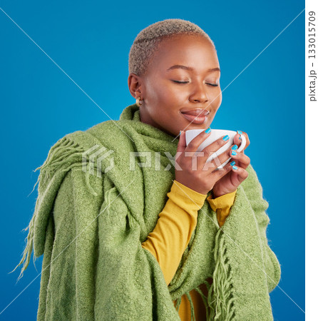 Coffee, scent and a black woman on a blue background in studio smelling the aroma for her mug. Relax, drink and easy with an attractive young female enjoying a fresh cup of caffeine during a break 133015709