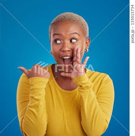 Black woman, gossip and secret in studio with hand on face for sale announcement. African female model on a blue background to whisper message, news information or wow rumor pointing at mockup deal Black woman, gossip and secret in studio with hand on face for sale announcement. African female model on a blue background to whisper message, news information or wow rumor pointing at mockup deal 133015734