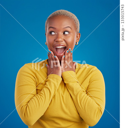 Black woman, happy and surprise face in studio for fashion, youth or notification by blue background. Young african girl, model or happiness with excited wow, announcement or deal with hands by mouth 133015743