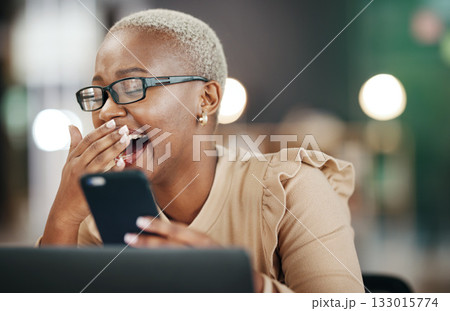 Black woman laughing, phone and reading online post, social media or internet meme in office, workplace and night bokeh. Happy person with funny video, chat or networking on smartphone or cellphone 133015774