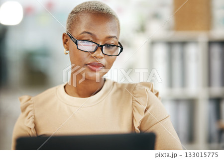Office, laptop and black woman with glasses, internet research and checking online report or email. Computer, concentration and serious, African journalist working on article on digital news website Office, laptop and black woman with glasses, internet research and checking online report or email. Computer, concentration and serious, African journalist working on article on digital news website 133015775