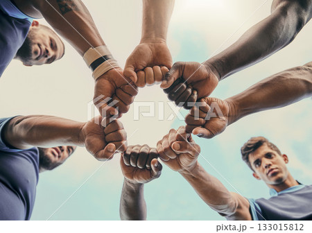 Hands, fist and solidarity with a sports team standing in a huddle for unity or motivation before a game. Fitness, teamwork and diversity with a group of men in a circle, getting ready for a match 133015812