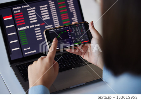Stock trading chart, laptop and phone in hands of woman for crypto, data analysis and bitcoin screen. Fintech growth, ecommerce and girl on technology for financial statistics, profit and investment Stock trading chart, laptop and phone in hands of woman for crypto, data analysis and bitcoin screen. Fintech growth, ecommerce and girl on technology for financial statistics, profit and investment 133015955