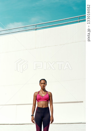 Sports, workout and portrait of serious woman with mockup, blue sky and vertical wall background at outdoor gym. Fitness, exercise and athlete with focus, sweat and healthy mindset for summer goals. Sports, workout and portrait of serious woman with mockup, blue sky and vertical wall background at outdoor gym. Fitness, exercise and athlete with focus, sweat and healthy mindset for summer goals. 133016082