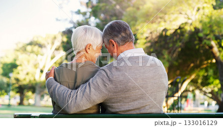 Senior couple, hug and bench outdoor in a park with love, care and support in marriage. A elderly man and happy woman in nature with a smile for quality time, healthy retirement and freedom to relax 133016129