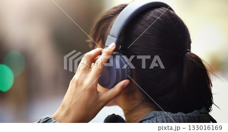 Woman with headphones in city, back view and listen to music, freedom and technology outdoor. Mockup space, podcast or radio streaming with female person in urban street and audio playlist Woman with headphones in city, back view and listen to music, freedom and technology outdoor. Mockup space, podcast or radio streaming with female person in urban street and audio playlist 133016169