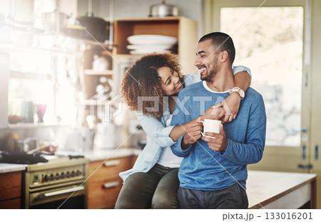 Love, coffee and happy couple in kitchen, morning hug in home with smile, hugging and healthy relationship. Happiness, man and woman embrace with affection, romance and young people in apartment. Love, coffee and happy couple in kitchen, morning hug in home with smile, hugging and healthy relationship. Happiness, man and woman embrace with affection, romance and young people in apartment. 133016201