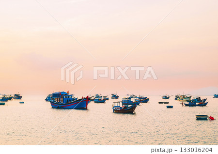 Traditional Vietnamese fishing boats at sea in Vietnam at sunset in Asia Traditional Vietnamese fishing boats at sea in Vietnam at sunset in Asia 133016204