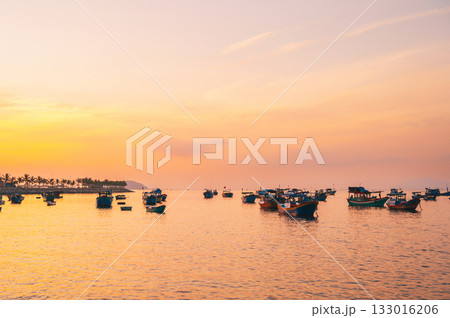 Traditional Vietnamese fishing boats at sea in Vietnam at sunset in Asia 133016206