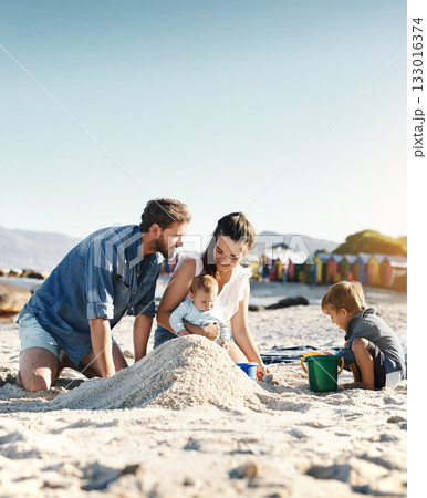 Sandcastle, holiday and children at the beach with family, love and support. Baby, mom and dad together with kids playing in the sun with happiness and smile by the ocean and mockup with bonding 133016374