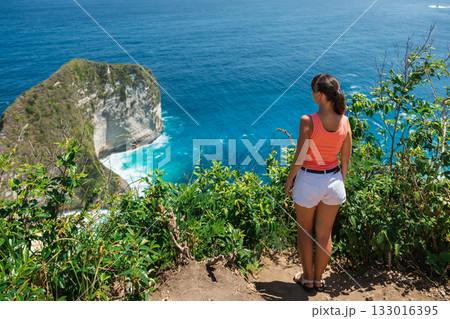 Woman and paradise Kelingking beach in Nusa Penida island, Indonesia. Woman and paradise Kelingking beach in Nusa Penida island, Indonesia. 133016395