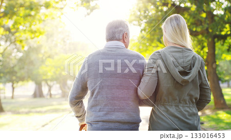 Senior man, daughter and walking outdoor at a park with love, care and support for health and wellness. A elderly male and woman of family in nature for a walk, quality time and healthy retirement 133016453