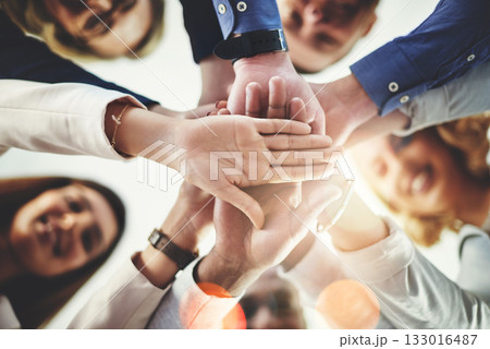 Team, hands of colleagues together and smile with huddle for collaboration for goal with lens flare. Teamwork or cooperation, businesspeople or coworkers and happy people with hand for support 133016487