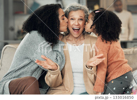 Portrait, kiss and grandmother with girl and woman on a sofa, smile and happy at family home together. Kissing, face and excited senior with adult daughter and grandchild on couch, bond and joy 133016850