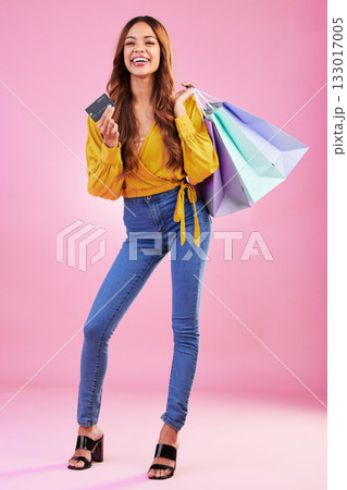 Woman with paper bag, shopping and smile with credit card for payment, retail and commerce on pink background. Customer, buy product at store or boutique, promotion and happy female in studio Woman with paper bag, shopping and smile with credit card for payment, retail and commerce on pink background. Customer, buy product at store or boutique, promotion and happy female in studio 133017005