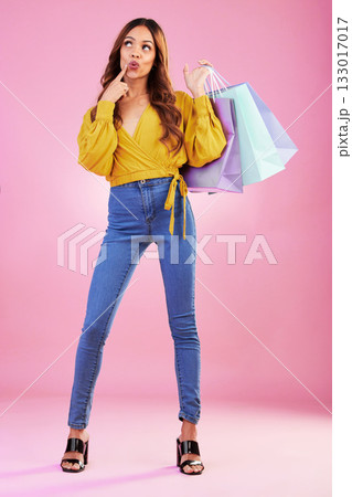 Woman is thinking about customer experience, shopping bag and retail with fashion sale on pink background. Purchase, service and product choice, thoughtful female in studio and discount at shop Woman is thinking about customer experience, shopping bag and retail with fashion sale on pink background. Purchase, service and product choice, thoughtful female in studio and discount at shop 133017017