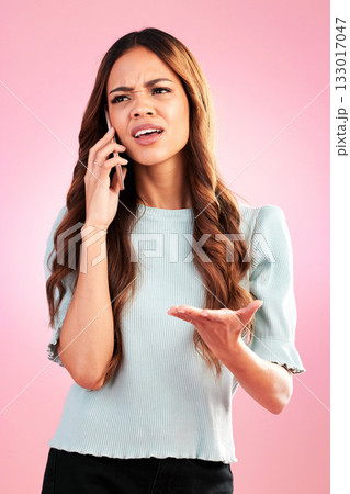 Annoyed, phone call and confused with woman in studio for angry, communication and bad news. Problem, conflict and frustrated with female isolated on pink background for negative, upset and contact Annoyed, phone call and confused with woman in studio for angry, communication and bad news. Problem, conflict and frustrated with female isolated on pink background for negative, upset and contact 133017047