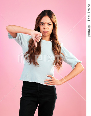 Portrait, thumbs down and hands of sad woman in studio for bad review, complaint or disappointed on pink background. Face, finger and emoji expression by girl with vote for wrong, bad news or reject Portrait, thumbs down and hands of sad woman in studio for bad review, complaint or disappointed on pink background. Face, finger and emoji expression by girl with vote for wrong, bad news or reject 133017078