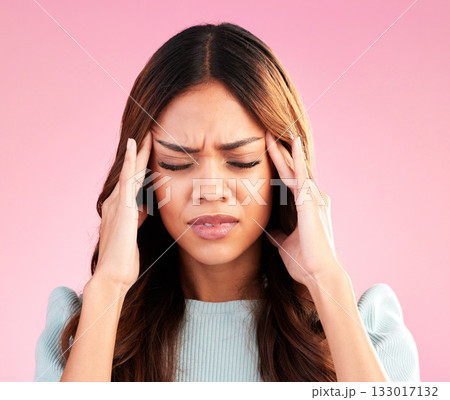 Stress, anxiety and depression, woman with headache in studio, tired and exhausted on pink background. Mental health, burnout and depressed hispanic model with hand on head in pain and temple massage Stress, anxiety and depression, woman with headache in studio, tired and exhausted on pink background. Mental health, burnout and depressed hispanic model with hand on head in pain and temple massage 133017132