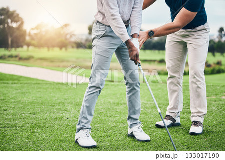 Golf lesson, sports teaching and coach hands helping a man with swing and stroke outdoor. Lens flare, green course and club support of a athlete ready for exercise, fitness and training for a game 133017190