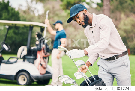 Golf, club and black man choose on course with golfing bag ready to start game, practice and training. Professional golfer, activity and male caddy with choice for exercise, fitness and recreation 133017246