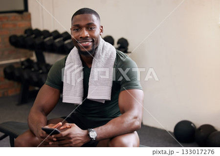 Gym, phone and portrait of happy man rest to check social media, search internet and workout progress app. Black male, sports break and mobile technology for fitness, smile and bodybuilder training 133017276