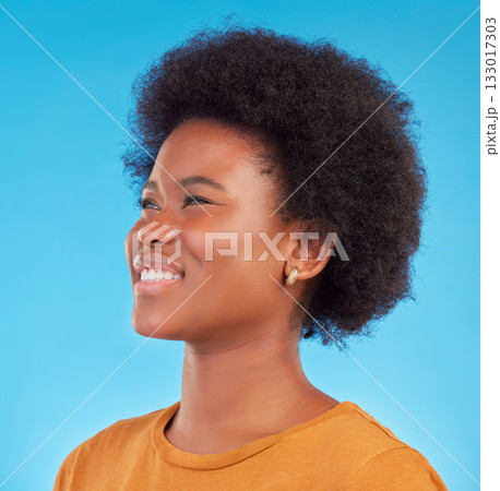 Thinking, smile and happy black woman wondering looking away in thought isolated against a blue studio background. Afro, casual and face of young African American female relax, calm and confident Thinking, smile and happy black woman wondering looking away in thought isolated against a blue studio background. Afro, casual and face of young African American female relax, calm and confident 133017303