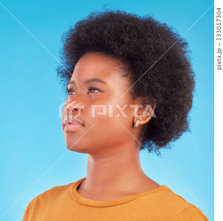 Thinking, idea and black woman wondering looking away in thought isolated against a blue studio background. Afro, casual and face of young African American female relax, calm and confident 133017304