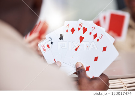 Game, holding and man playing cards, poker or black jack at a casino. Back, games and a guy showing a card in hands while gambling, having fun and learning a magic trick for s hobby or activity 133017474