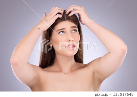 Woman, hair and worried of scalp dandruff on studio background to scratch allergy, eczema or head lice. Female model, itching scalp and haircare problem of damaged texture, dry skincare or dermatitis 133017649