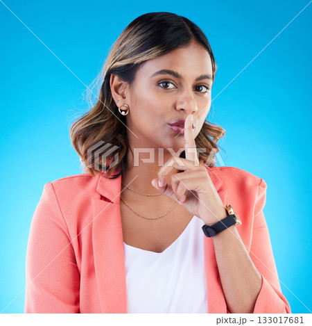 Secret, portrait and woman with finger on lips in studio, blue background and privacy sign. Young female model, silence and quiet on mouth, shush and gossip of whisper, emoji and confidential mystery Secret, portrait and woman with finger on lips in studio, blue background and privacy sign. Young female model, silence and quiet on mouth, shush and gossip of whisper, emoji and confidential mystery 133017681