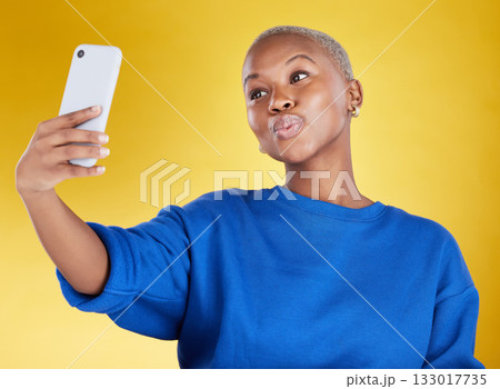 Selfie, smile and beauty of black woman in studio isolated on a yellow background. Photographer, social media and African female model taking pictures or photo for profile picture and happy memory. Selfie, smile and beauty of black woman in studio isolated on a yellow background. Photographer, social media and African female model taking pictures or photo for profile picture and happy memory. 133017735