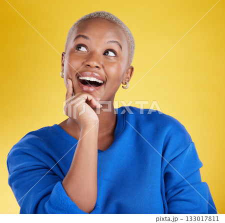 Wow, thinking and aha with a black woman in studio on a yellow background looking thoughtful or surprised. Idea, wonder and eureka with an attractive young female feeling shocked or contemplative 133017811