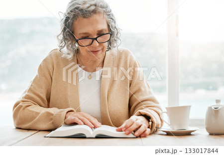 Old woman reading book, story or bible to relax in hobby or retirement for peace or learning religion. Elderly studying or calm senior person with novel for information or knowledge on table at home Old woman reading book, story or bible to relax in hobby or retirement for peace or learning religion. Elderly studying or calm senior person with novel for information or knowledge on table at home 133017844