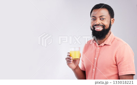 Orange juice, studio portrait and happy black man with drink glass for hydration, liquid detox or weight loss beverage. Vitamin C benefits, male nutritionist diet or person on mockup gray background 133018221