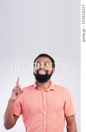 Point, mockup space and black man looking up with hand gesture for product placement, advertising and sign. Happy, studio and male smile on white background pointing for choice, branding and showing Point, mockup space and black man looking up with hand gesture for product placement, advertising and sign. Happy, studio and male smile on white background pointing for choice, branding and showing 133018227