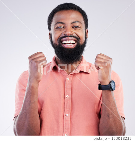 Portrait, happy black man and fist of winner in studio of celebration, achievement deal or success. Excited male model celebrate winning news, lottery giveaway and smile of victory, motivation or yes 133018233