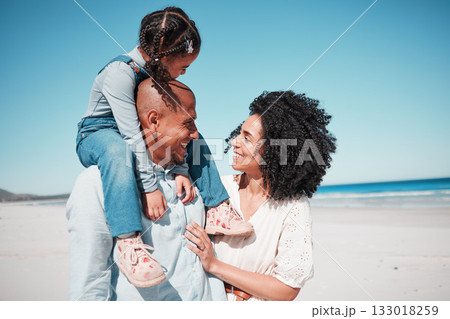 Happy, love and family at the beach while on a vacation, adventure or summer weekend trip. Happiness, smile and girl child by the ocean with her parents while on a tropical seaside holiday in Mexico. 133018259