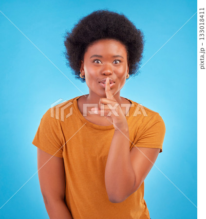 Secret, portrait and black woman with finger on lips in studio, background and privacy of drama news. Excited model, silence and shush on mouth, quiet emoji or whisper gossip of confidential surprise 133018411