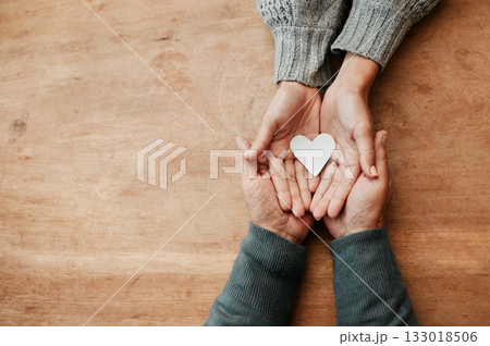 Hands, heart and shape for love, support or care above in trust, unity or compassion together on mockup table. Top view of hand holding for family generation, hope or symbol in bonding relationship Hands, heart and shape for love, support or care above in trust, unity or compassion together on mockup table. Top view of hand holding for family generation, hope or symbol in bonding relationship 133018506