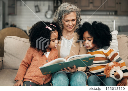 Family children, book and grandma reading fantasy storybook, story or bond on home living room sofa. Love, grandma babysitting and elderly woman with child development for biracial kindergarten kids Family children, book and grandma reading fantasy storybook, story or bond on home living room sofa. Love, grandma babysitting and elderly woman with child development for biracial kindergarten kids 133018520